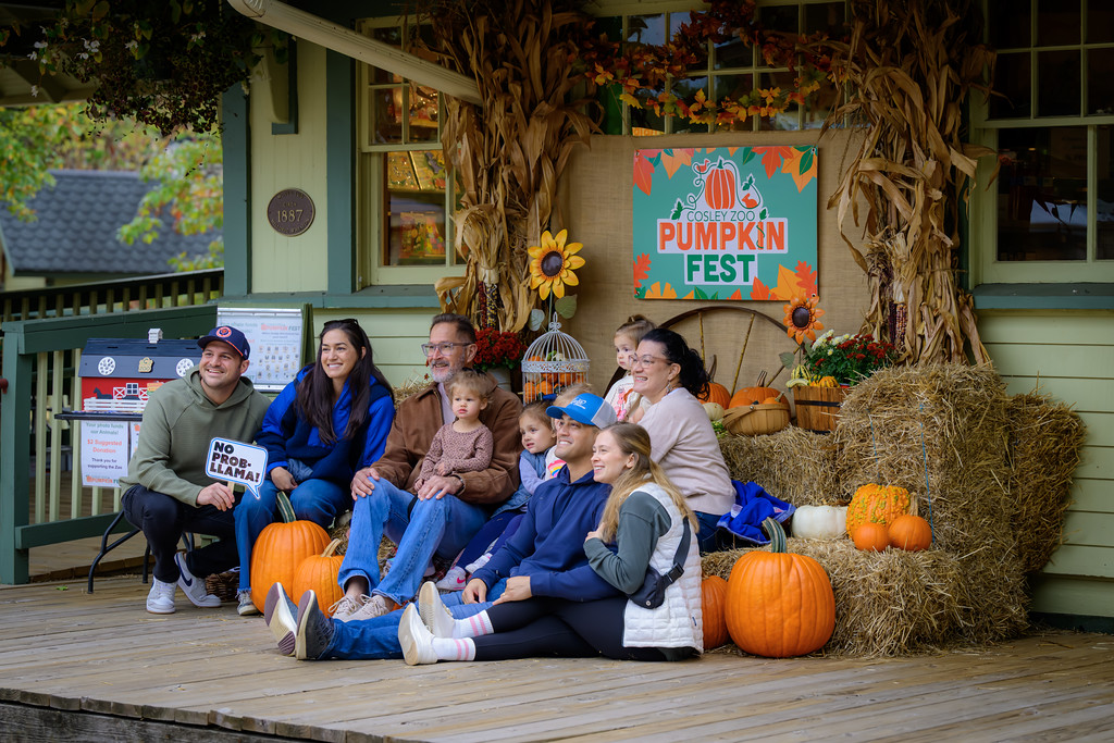 A family having their picture taken with pumpkins