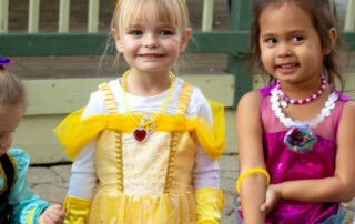 Four little girls dressed up as princesses