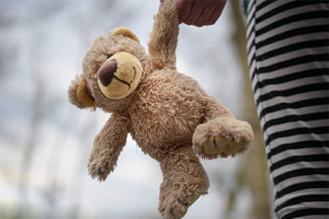 teddy bear and child teddy bear held by child